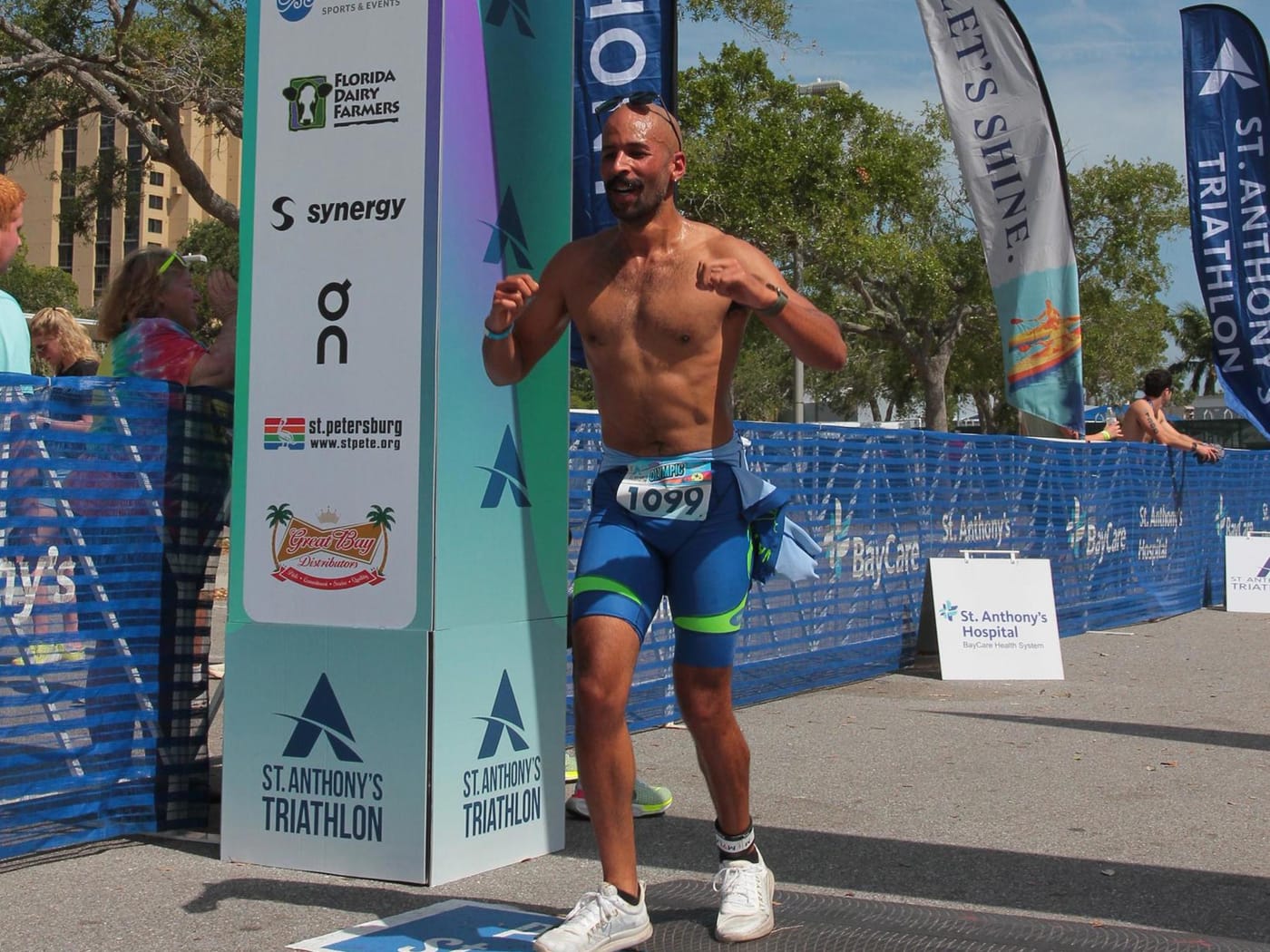 Tarik Hamilton crosses the line under the clock at the 2024 St. Anthony's Triathlon.