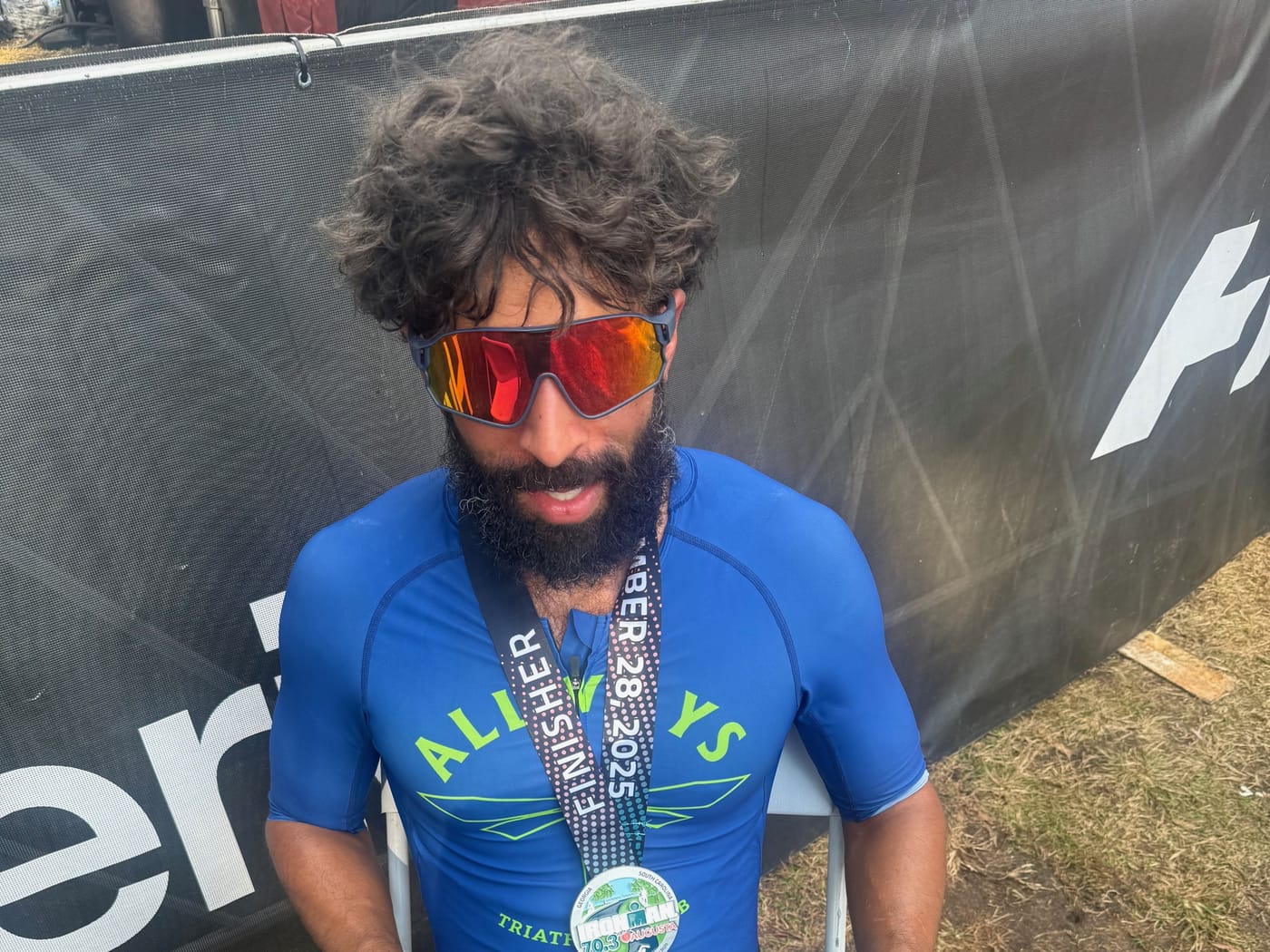 Tarik Hamilton with the medal after the 2025 IRONMAN 70.3 Augusta.